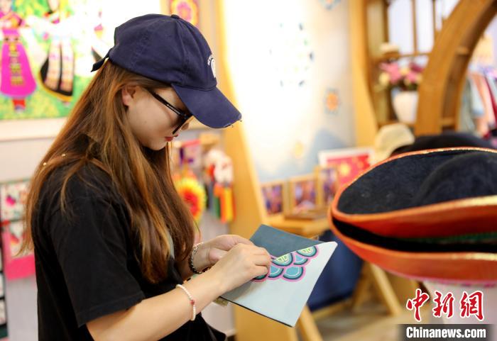 圖為民眾體驗國家級非遺項目盤繡技藝?！⊙Φ?攝