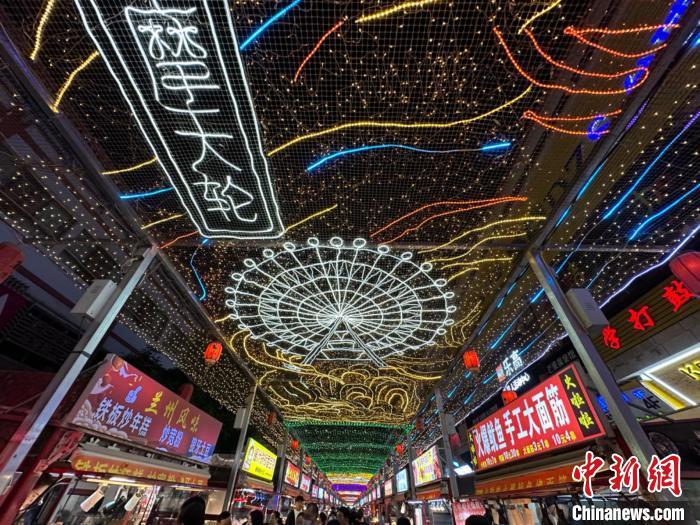 圖為明清街夜市燈光點(diǎn)亮具有武威文化元素的“摩天輪”彩燈?！〈魑牟?攝</p><p>