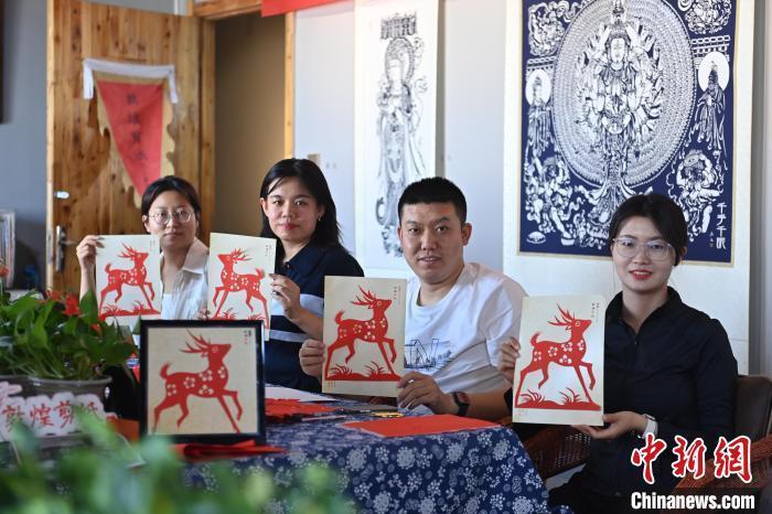 6月6日，在甘肅敦煌青年夜校課程中，青年學(xué)員展示學(xué)習(xí)敦煌非遺剪紙的成果。李亞龍 攝　　